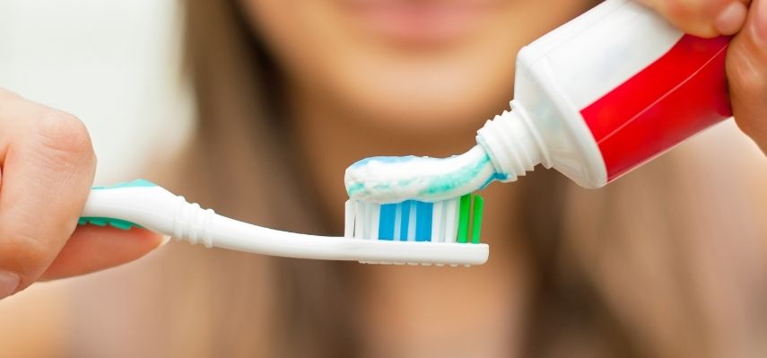 What is the role of toothpaste in cleaning teeth
